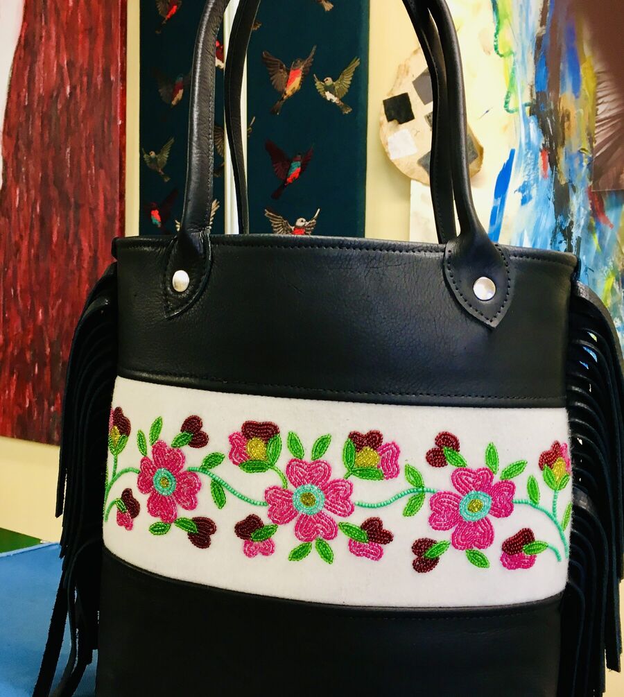 Black leather tote with beaded roses and fringe